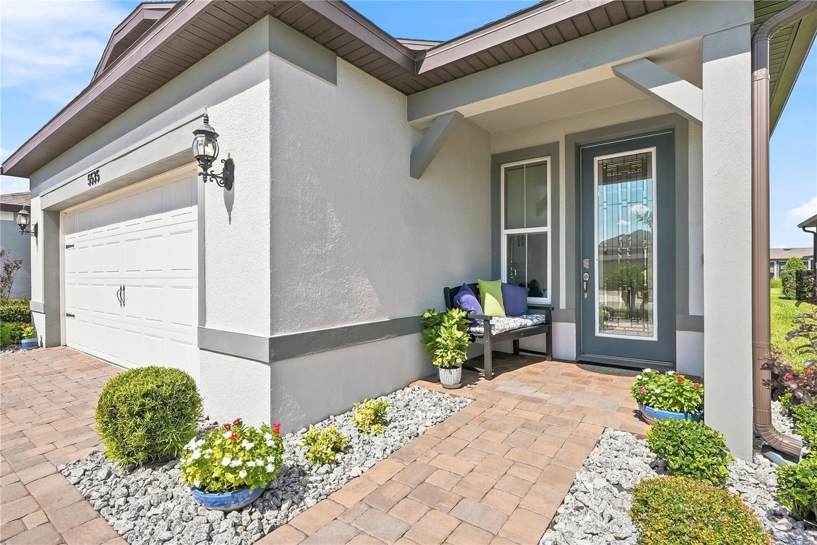 Pavers extend from the driveway to the covered front door. - 5535 BLUE CRUSH BND, LAND O LAKES