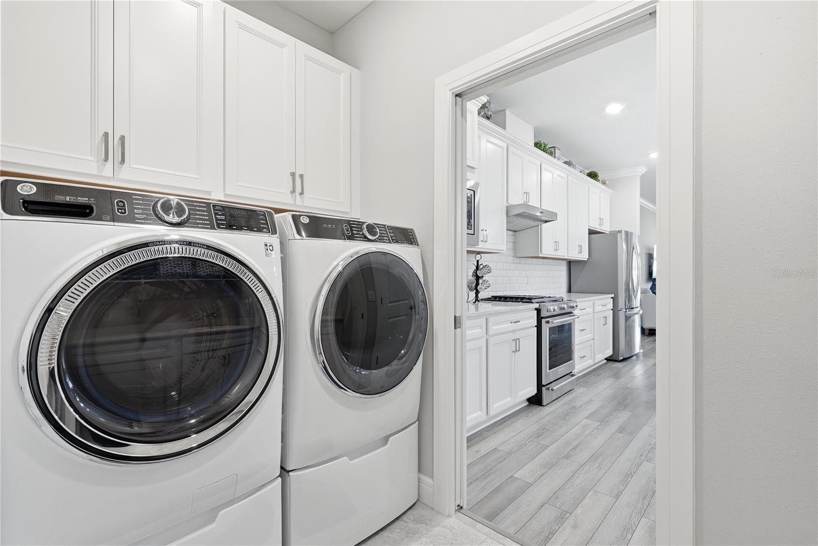 Front Loaders Washer and Dryer on pedestals with storage. - 5535 BLUE CRUSH BND, LAND O LAKES