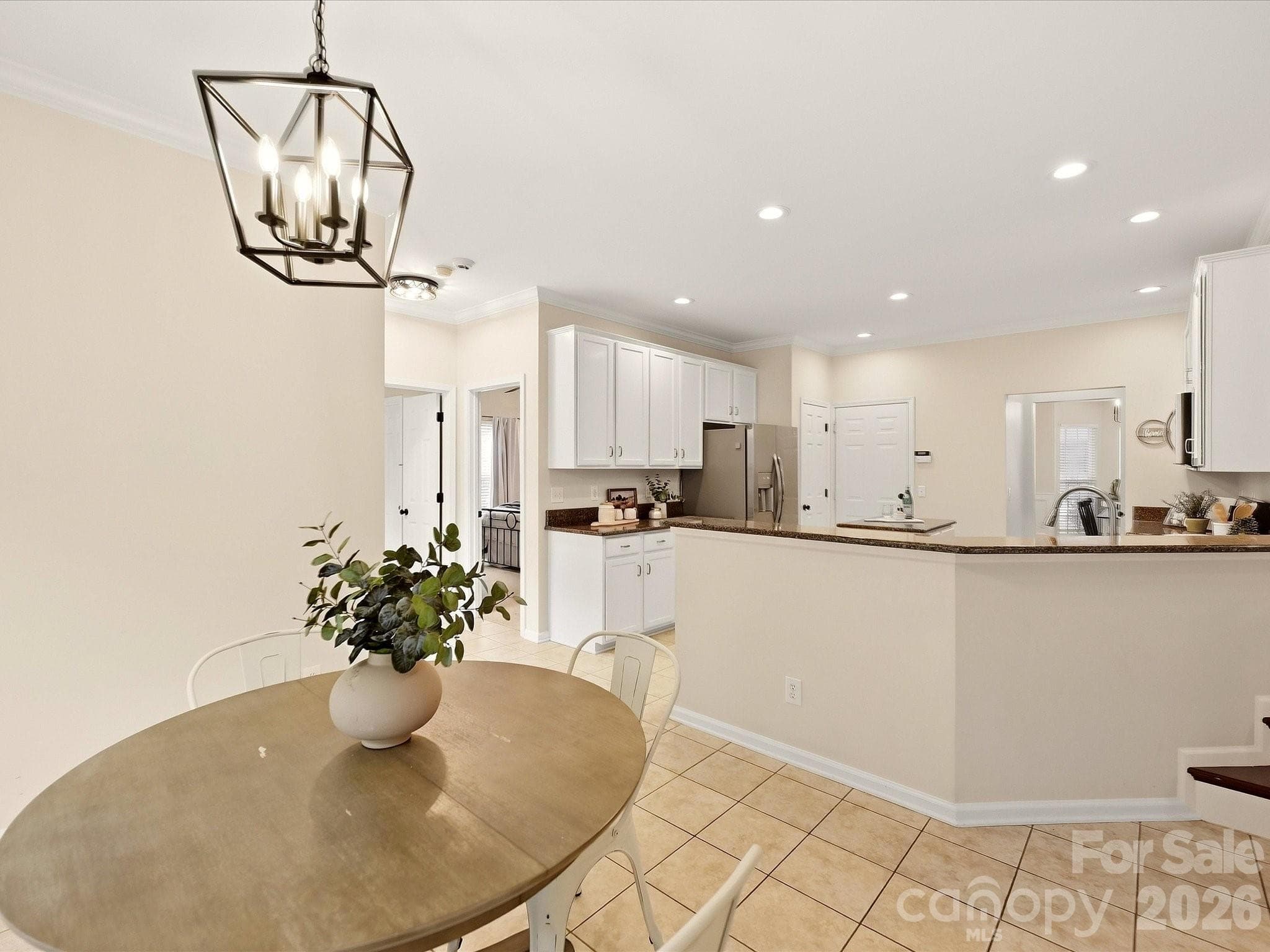 The bright breakfast nook features a charming bay window, abundant natural light, and an easy connection to the kitchen for casual everyday dining. - 16006 Lavenham Road, Huntersville