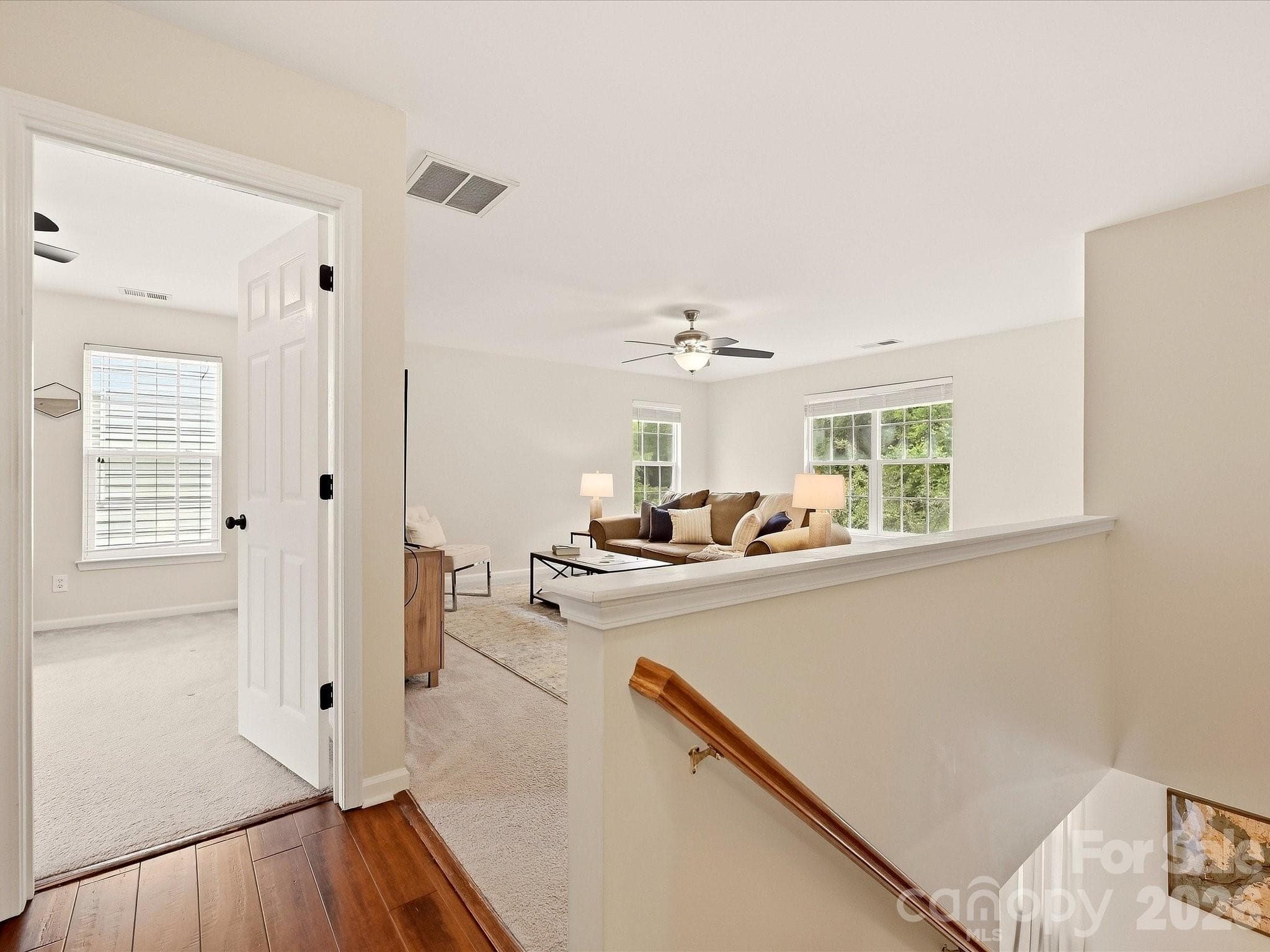 The bright upper-level landing opens to a spacious loft and additional bedroom, creating a flexible transition between the home’s upstairs living spaces. - 16006 Lavenham Road, Huntersville