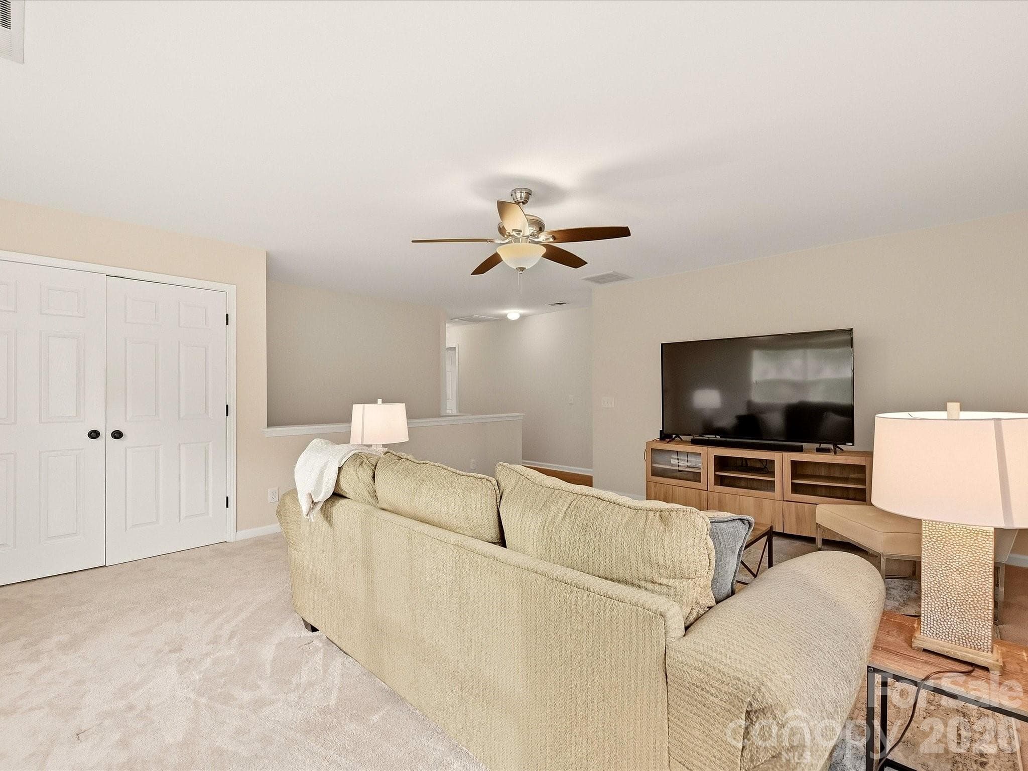 The spacious loft offers a bright, flexible second living area with abundant natural light and plenty of room for a media space, playroom, home office, or game room. - 16006 Lavenham Road, Huntersville