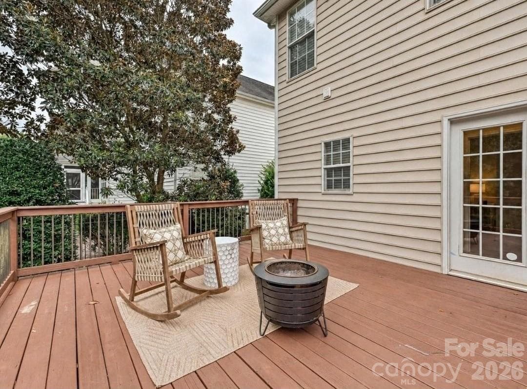 The spacious back deck offers a peaceful outdoor retreat with room for seating and relaxing views of the surrounding mature trees. - 16006 Lavenham Road, Huntersville