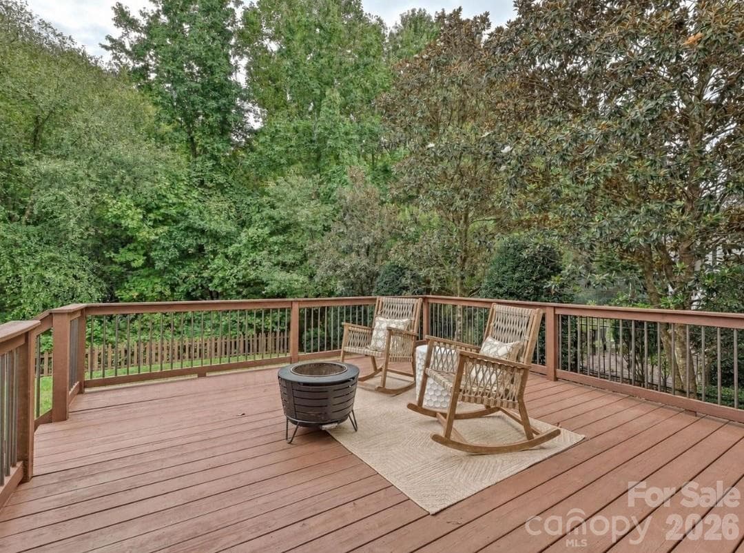 The spacious back deck offers a peaceful outdoor retreat with room for seating and relaxing views of the surrounding mature trees. - 16006 Lavenham Road, Huntersville