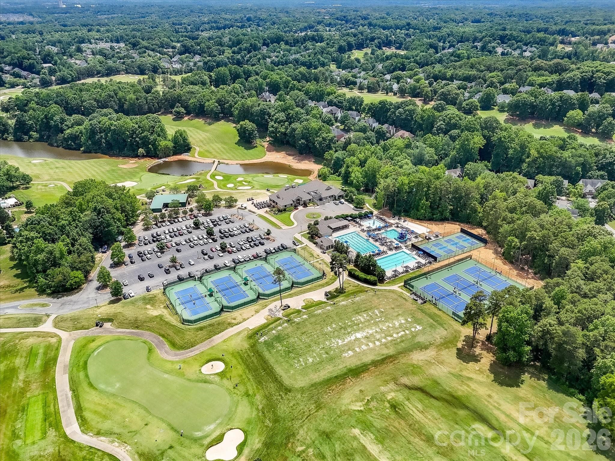 Aerial views of NorthStone showcase the community’s impressive amenities, including the golf course, clubhouse, swimming pools, tennis courts, and beautifully maintained grounds. - 16006 Lavenham Road, Huntersville