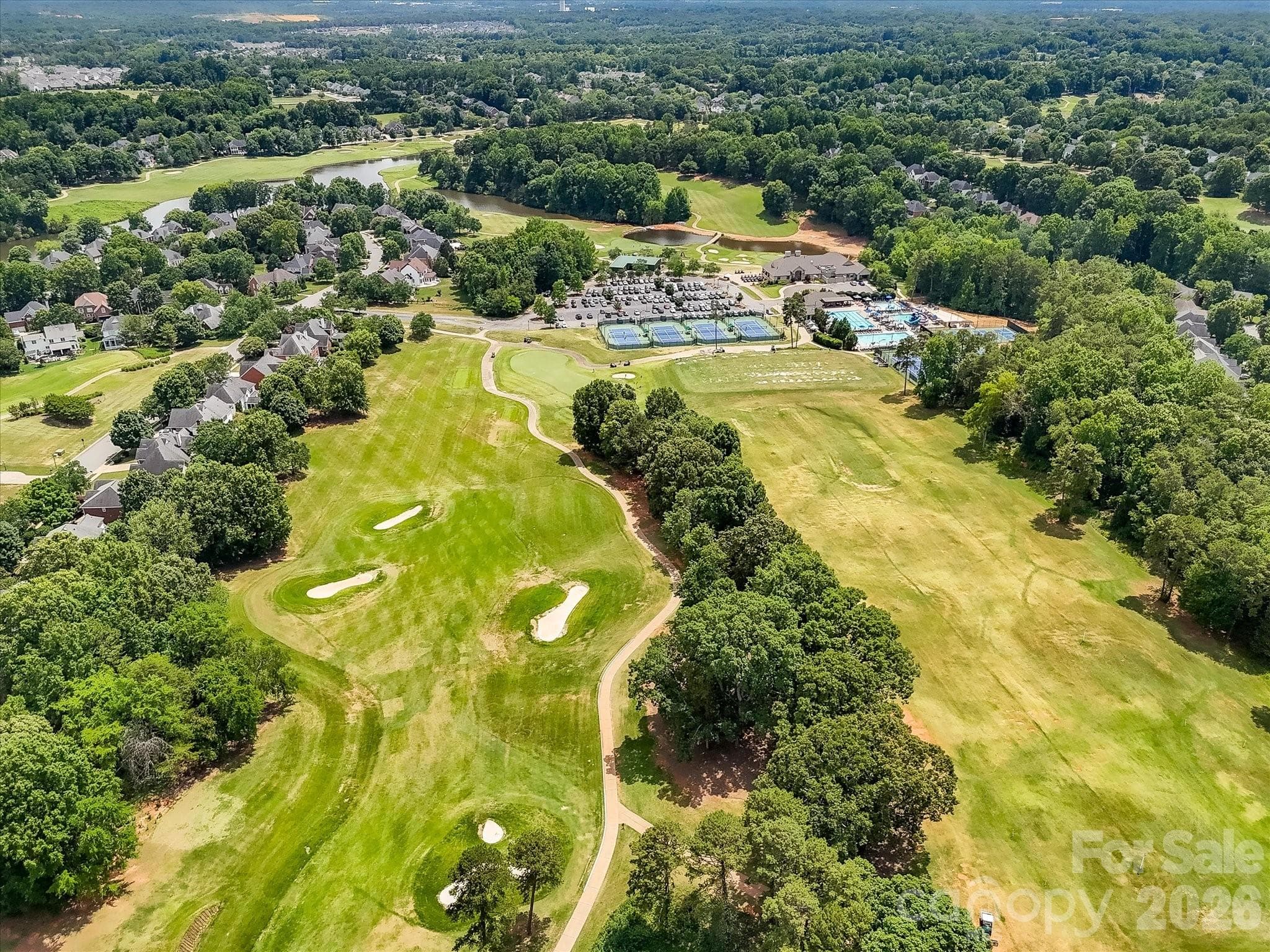 Aerial views of NorthStone showcase the community’s impressive amenities, including the golf course, clubhouse, swimming pools, tennis courts, and beautifully maintained grounds. - 16006 Lavenham Road, Huntersville