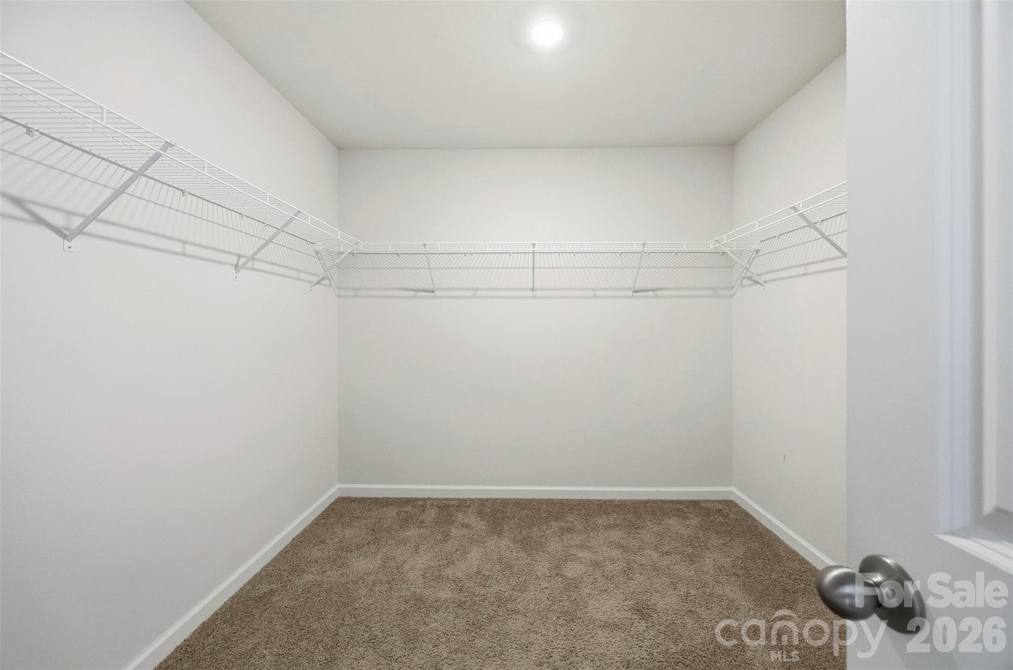Upper level primary bedroom walk in closet - 7572 Nolen Farm Drive, Gastonia
