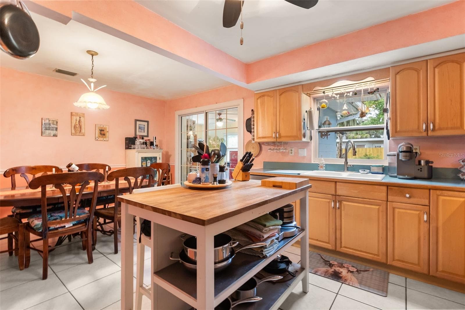 Kitchen, dining room, and sliding glass door to one of the bonus rooms. - 4511 LONGWORTH DR, ORLANDO