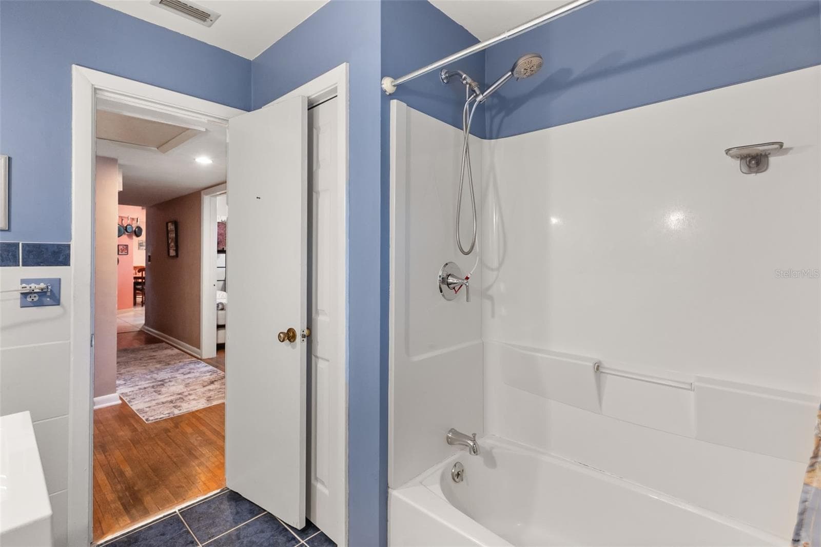 First floor guest bathroom with linen closet. Primary bedroom is down hallway to the left. Bedrooms 2 and 3 are to the right. Kitchen is straight ahead. - 4511 LONGWORTH DR, ORLANDO