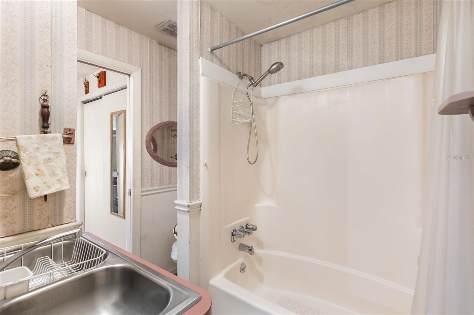 Upstairs bathroom with a kitchen sink for multigenerational living. - 4511 LONGWORTH DR, ORLANDO