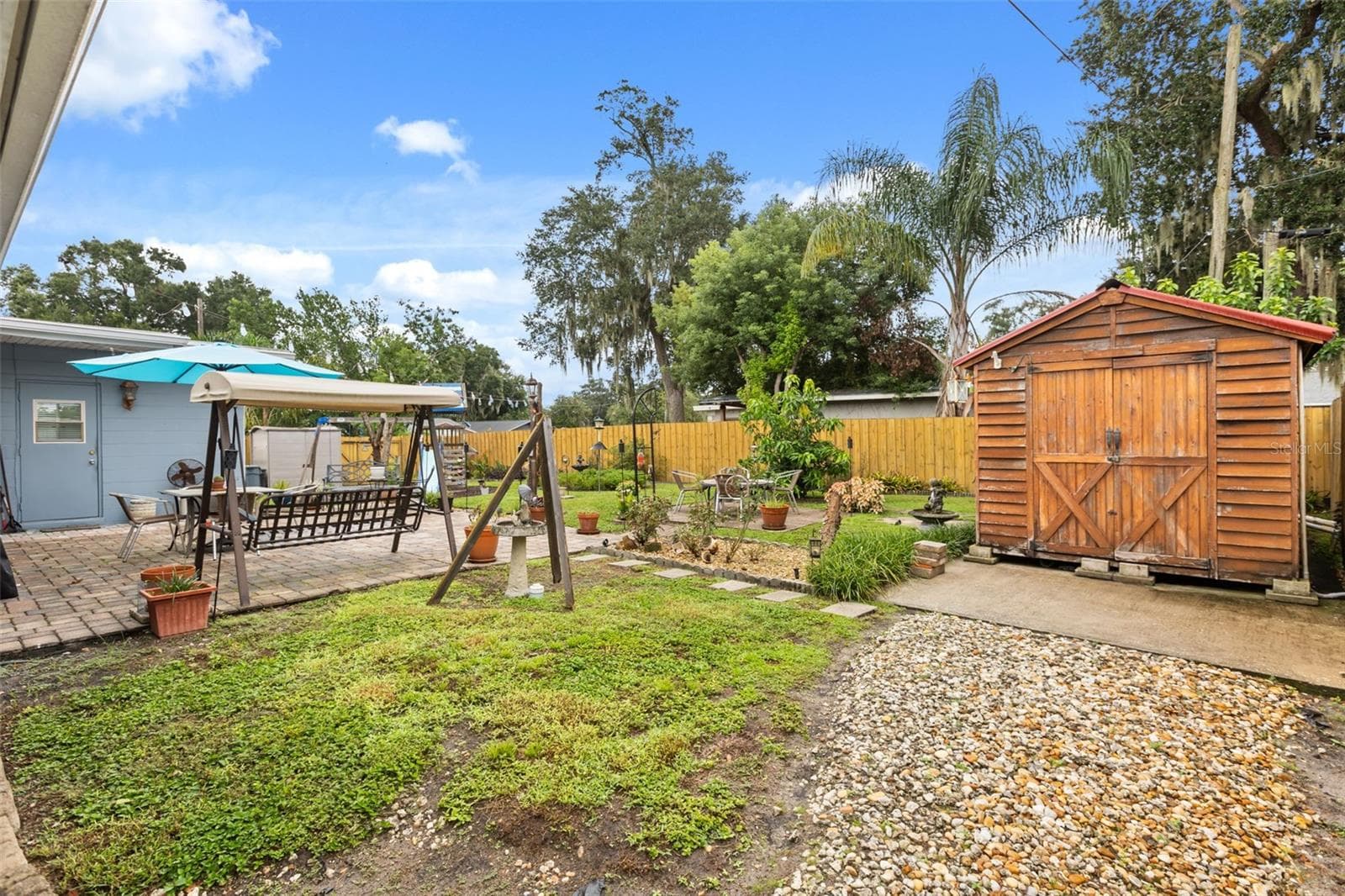 Pavered patio, beautiful landscaping, and shed. - 4511 LONGWORTH DR, ORLANDO