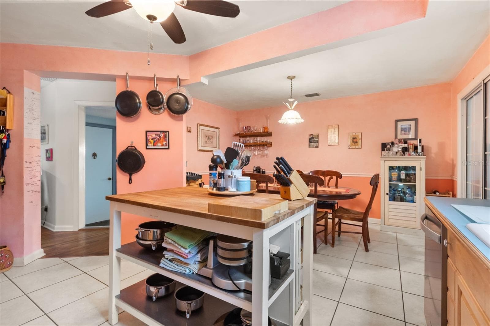 Kitchen is open to the dining room. The doorway leads to a bonus room. The far door leads to the upstairs. - 4511 LONGWORTH DR, ORLANDO