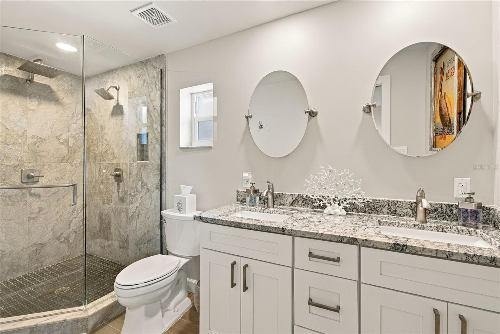 Roomy primary bath with double sink vanity and glass shower with double shower fixtures - 4501 TRASK ST, TAMPA