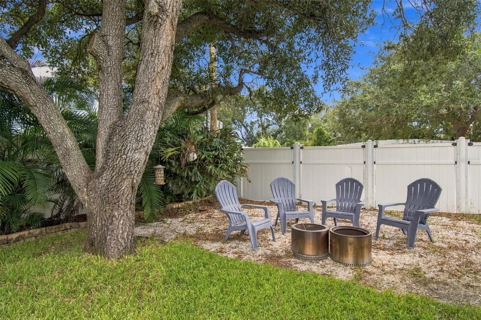 Your fully fenced yard is complete with beautiful trees and firepit area. - 4501 TRASK ST, TAMPA