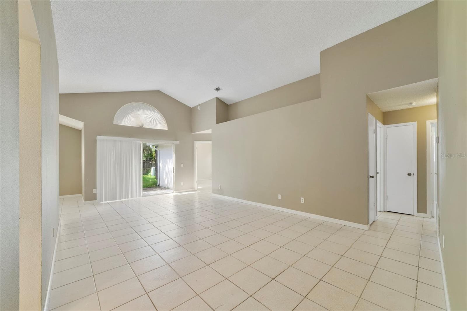 Step inside to a light and inviting floor plan featuring CERAMIC TILE FLOORING THROUGHOUT—NO CARPET! - 713 MEADOWSIDE CT, ORLANDO