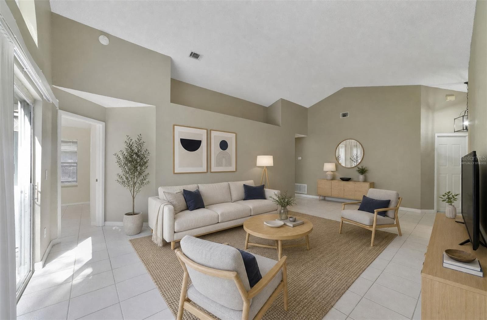 The spacious Living Room immediately catches your eye with its VAULTED CEILING, a unique decorative ledge and an ARCHED WINDOW positioned above the sliding glass doors that open to the back patio and SPACIOUS YARD, creating an easy connection between the indoor and outdoor spaces. Virtually Staged - 713 MEADOWSIDE CT, ORLANDO