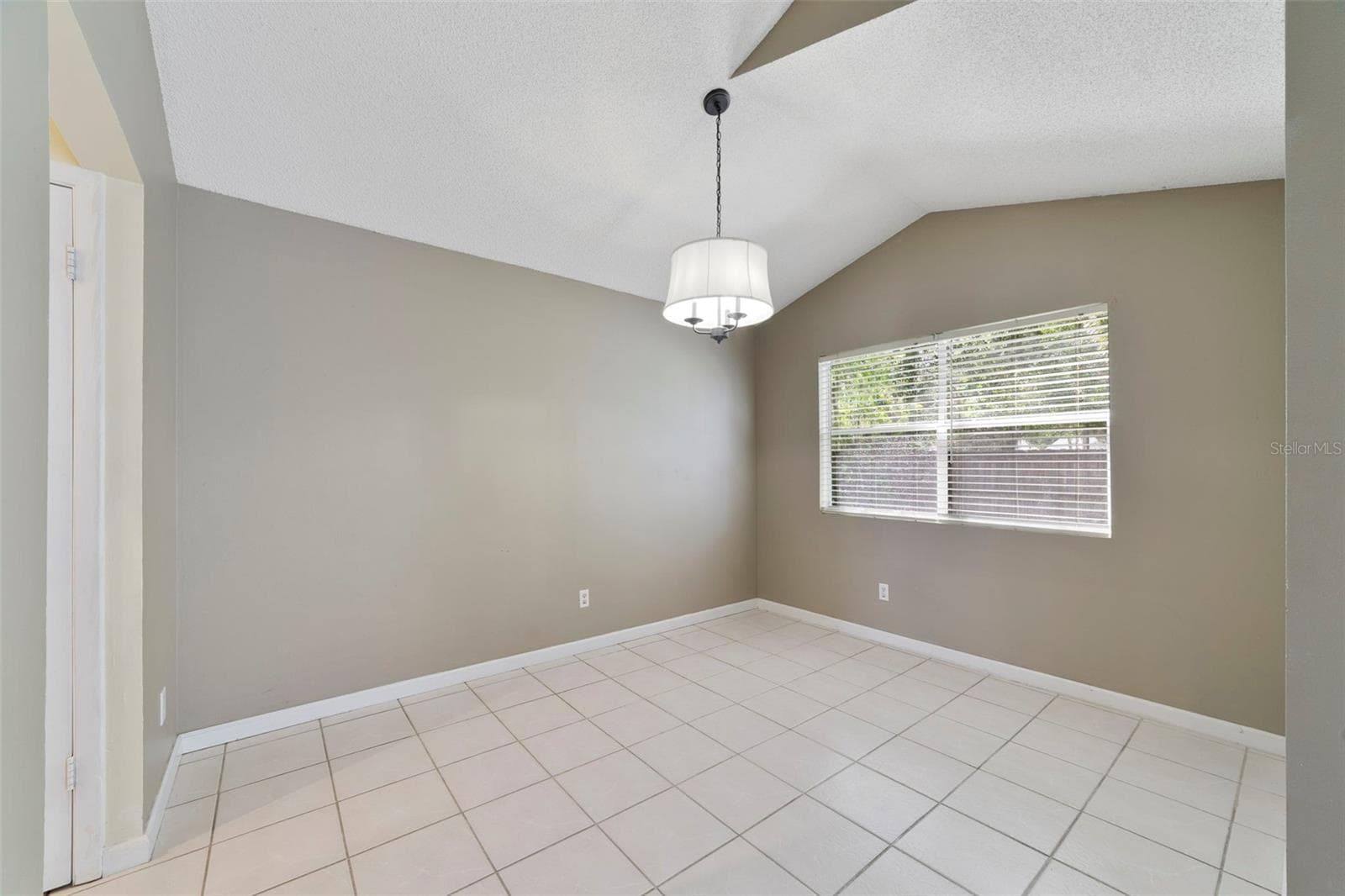 Nearby, the Dining Room enjoys a pleasant VIEW OF THE BACKYARD, and provides a comfortable setting for meals and gatherings. - 713 MEADOWSIDE CT, ORLANDO