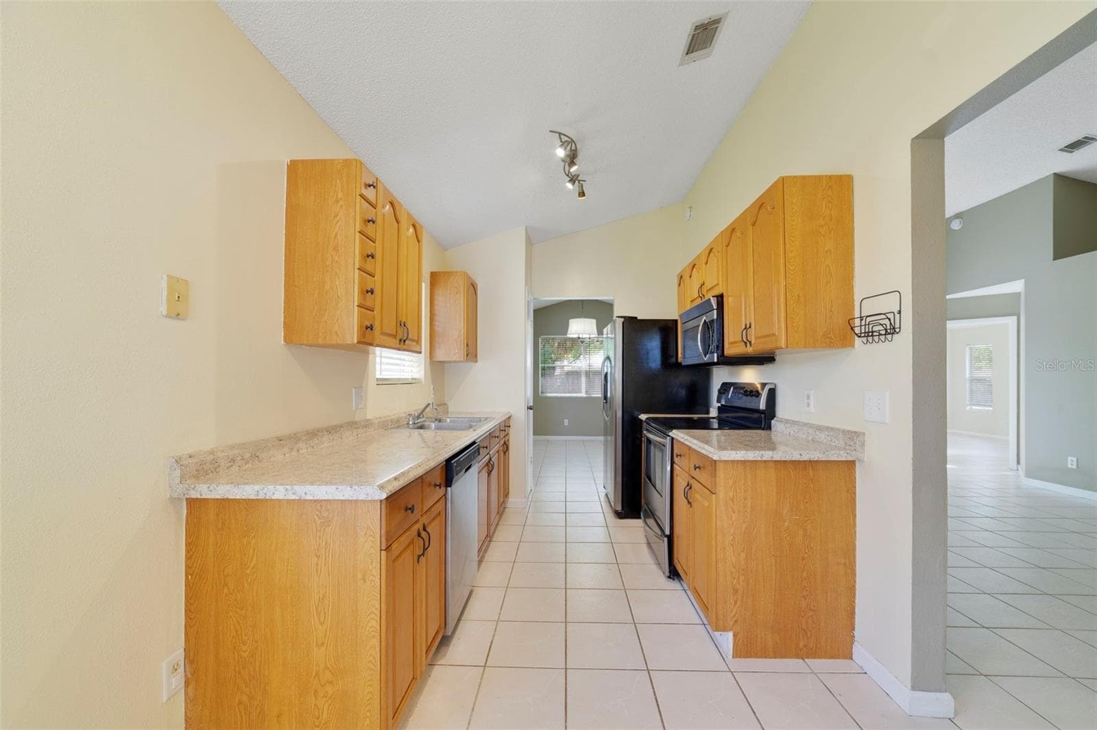 The Kitchen is conveniently located just off the main living spaces and features solid wood cabinetry, STAINLESS STEEL APPLIANCES, and a cozy, sunny BREAKFAST NOOK—a perfect spot for morning coffee or casual meals. - 713 MEADOWSIDE CT, ORLANDO