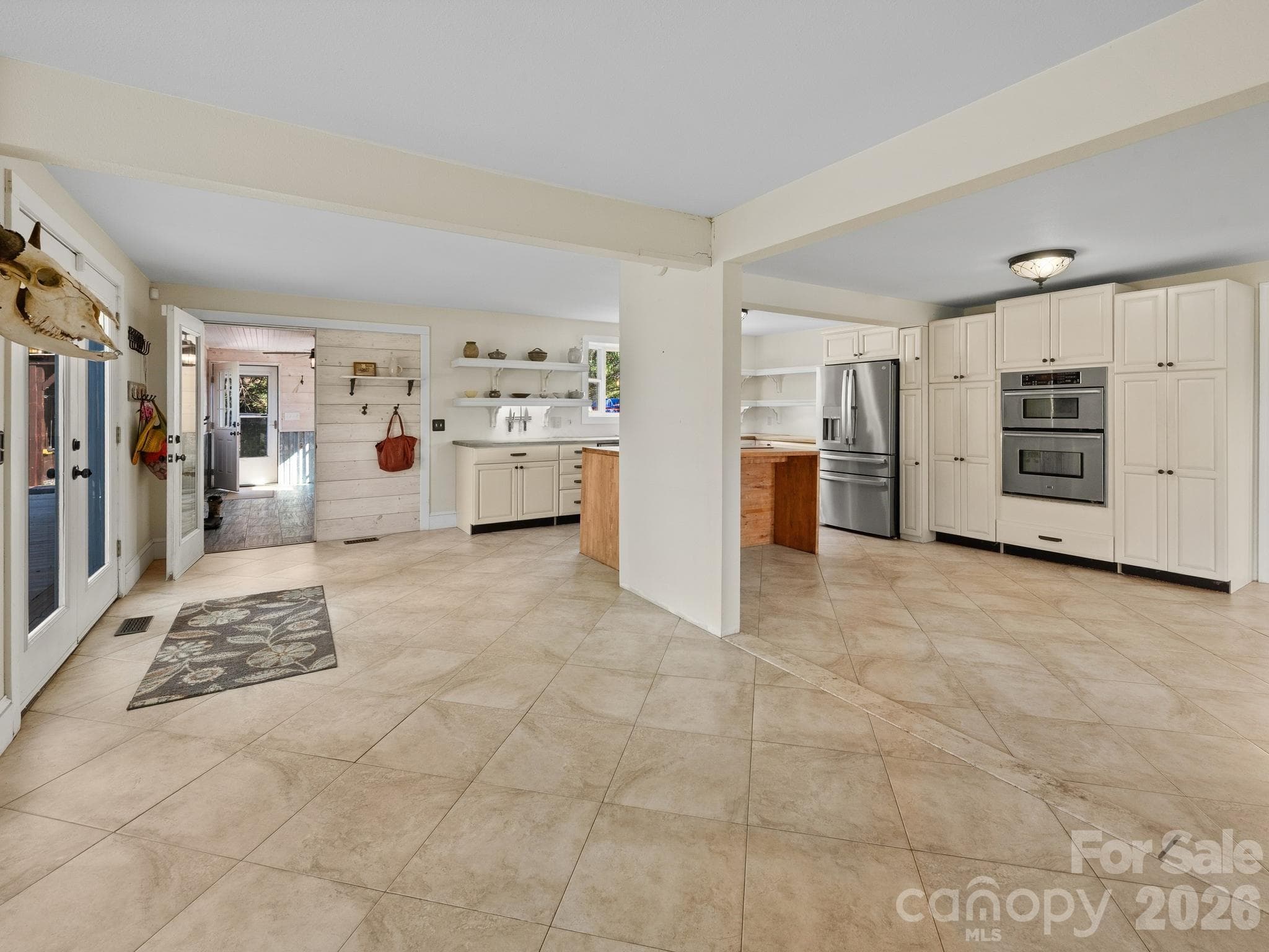 The heart of the home is a Great Room with doors leading out to the deck, a center cooking island, and a fireplace. - 157 J A Hampton Road, Rutherfordton