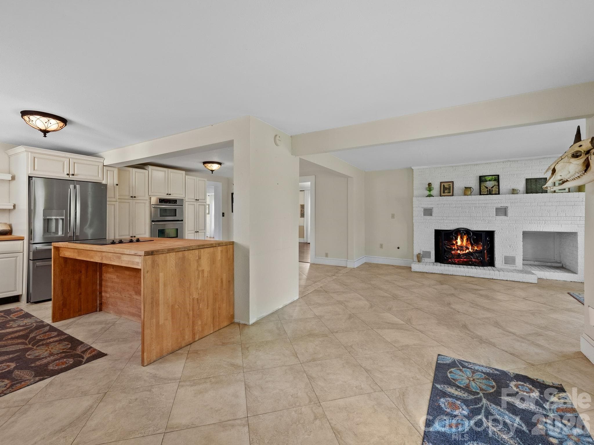 The heart of the home is a Great Room with a kitchen with quality cabinetry opening to an area for dining and another area for seating near the fireplace. - 157 J A Hampton Road, Rutherfordton