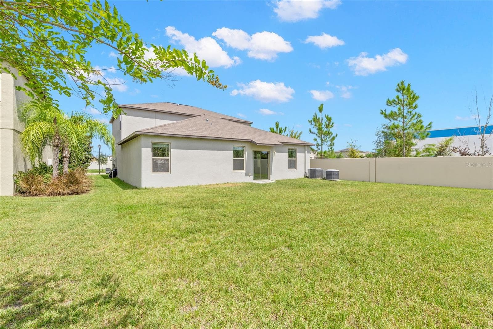 The oversized backyard is a standout, with a broad stretch of lawn and plenty of room to create a future outdoor living area, play space or pool. - 5061 WHITE CHICORY DR, APOLLO BEACH