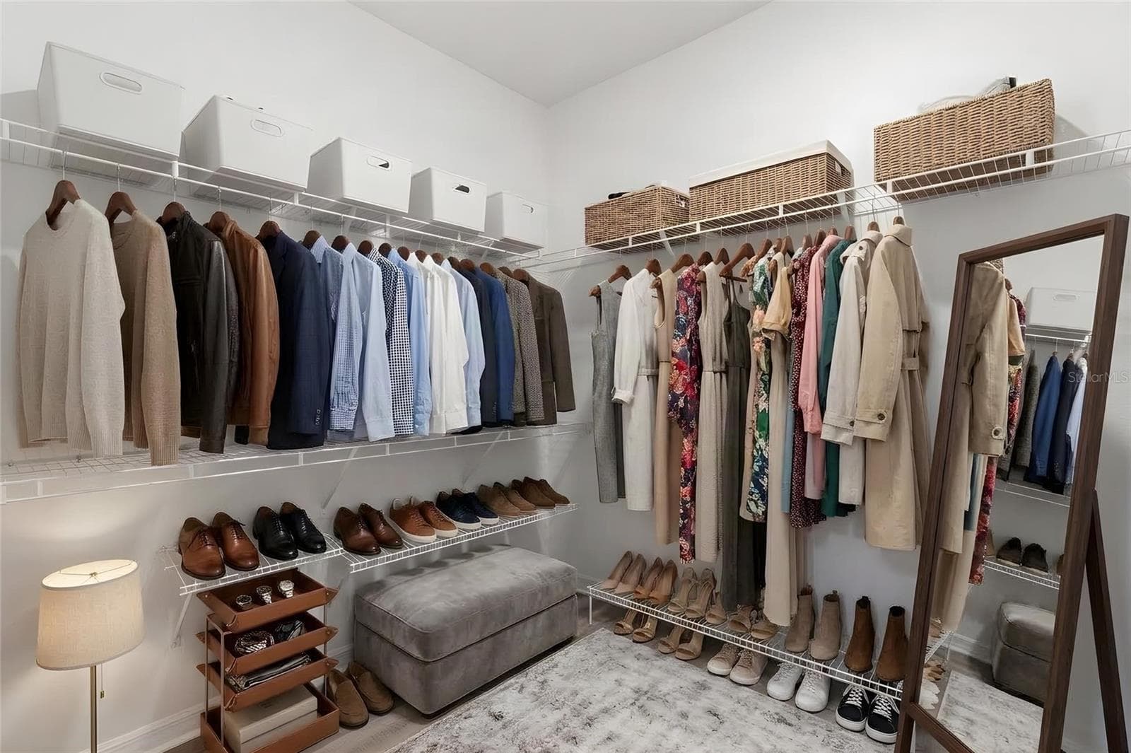 The primary suite includes a spacious walk-in closet with wraparound wire shelving and plenty of room for clothing, shoes and additional storage. - 5061 WHITE CHICORY DR, APOLLO BEACH