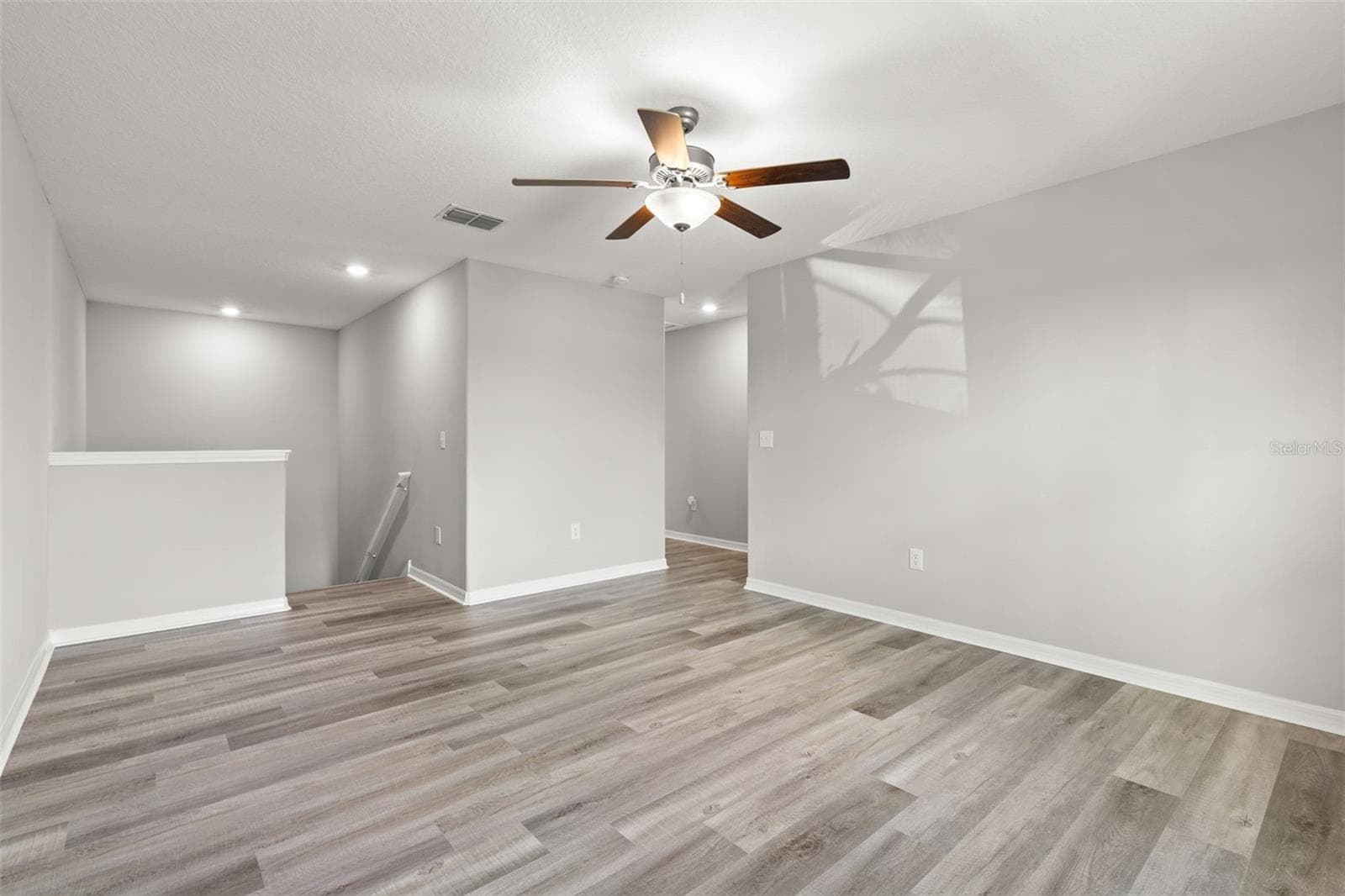 The oversized upstairs loft creates a true second living zone, with plenty of space for a media room, game area, home office or combination of uses. Newly replaced laminate flooring and fresh neutral paint keep the space clean and versatile. - 5061 WHITE CHICORY DR, APOLLO BEACH