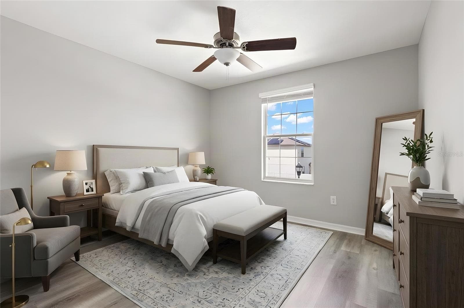 Bedroom 4 features newly replaced laminate flooring, fresh neutral paint, a ceiling fan and a large window that brings in plenty of natural light. - 5061 WHITE CHICORY DR, APOLLO BEACH