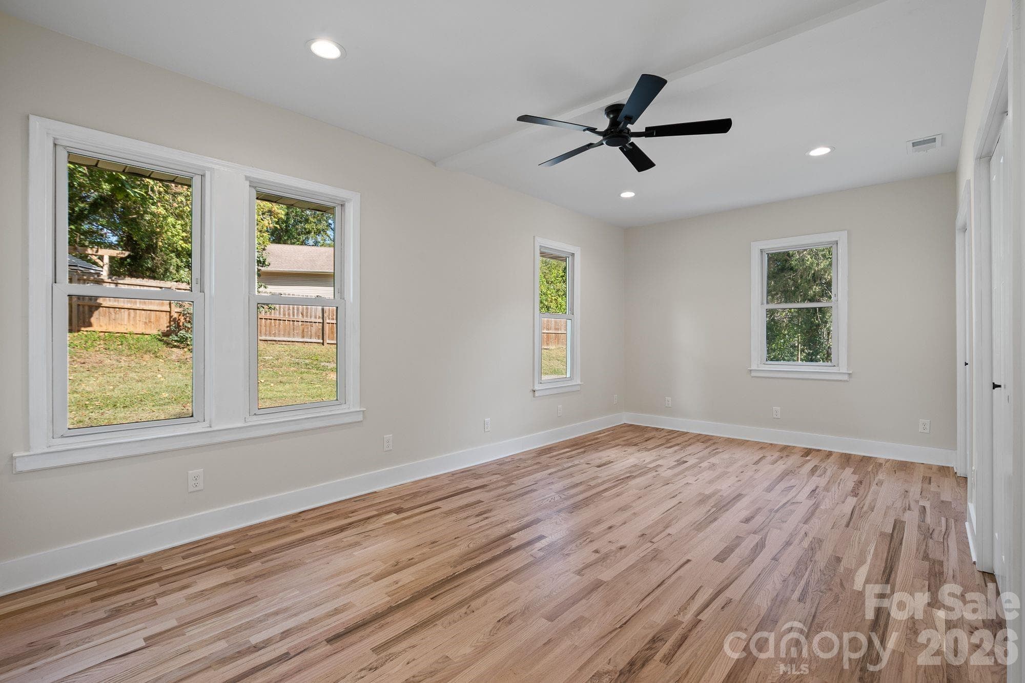 Primary Bedroom: Spacious main-level primary suite with private en-suite bath. - 156 State Street, Asheville