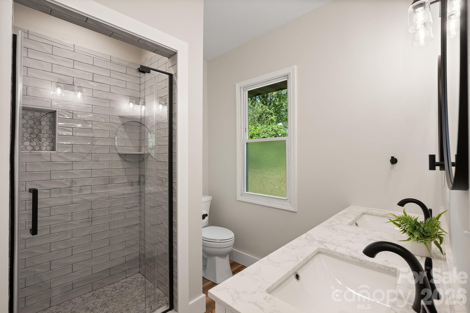 Primary En-Suite: Updated bathroom with custom walk-in tile shower and modern finishes. - 156 State Street, Asheville