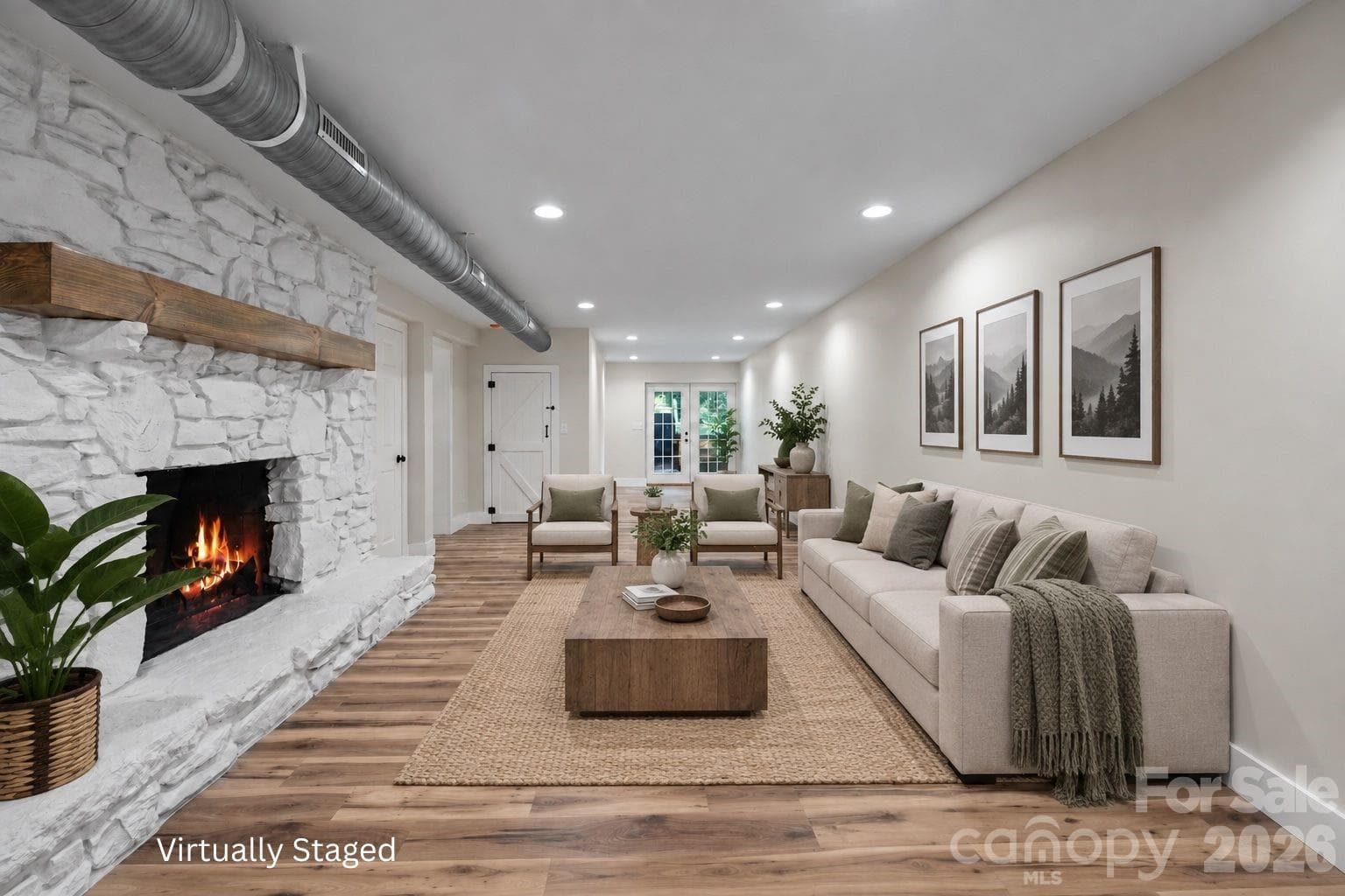 Virtually Staged Lower-Level Den: Expansive den with a second stone wood-burning fireplace. - 156 State Street, Asheville