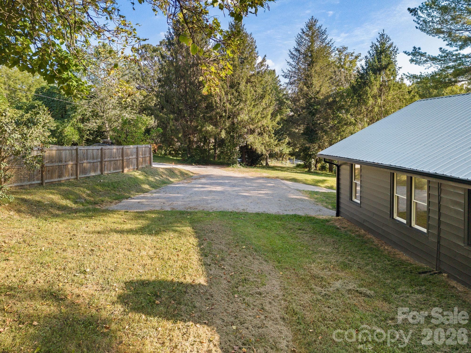 Private backyard and parking area with easy access from the home and ample outdoor living space. - 156 State Street, Asheville