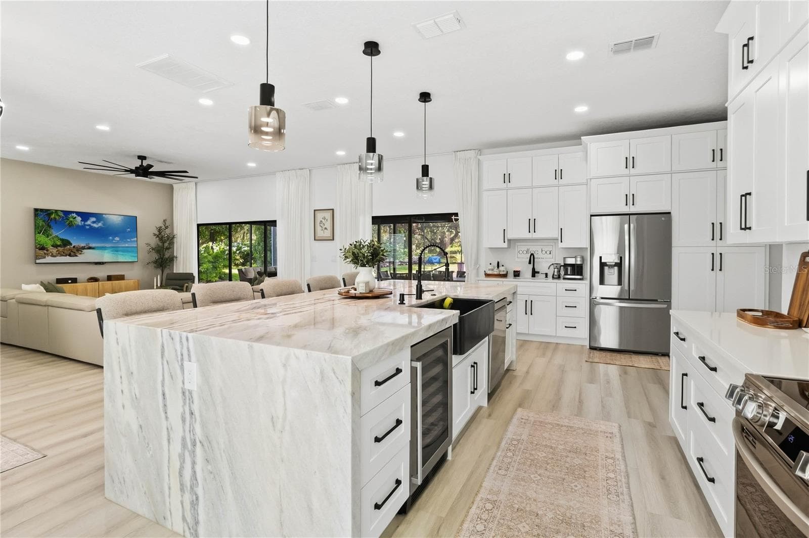 Kitchen Island with waterfall countertop, Wet Bar with 2nd sink to the left of the refigerator - 3180 WHISPER WIND DR, ST CLOUD