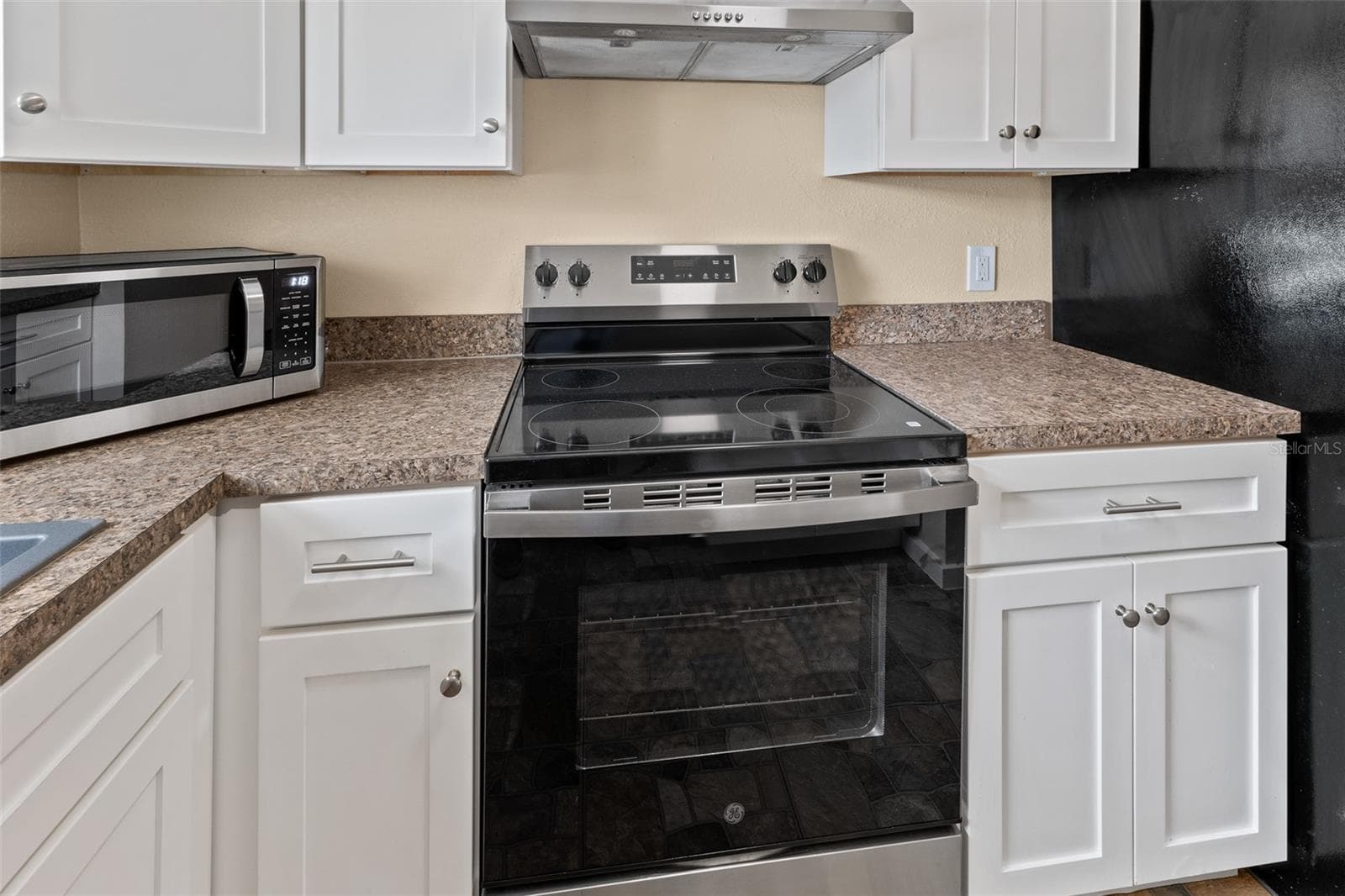 Kitchen close-up of stainless electric range and microwave - 1514 CLEARLAKE RD #2, COCOA