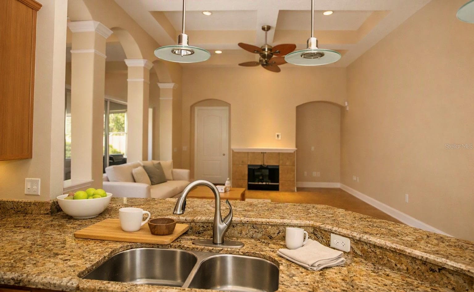 KITCHEN OVERLOOKING INTO FORMAL LIVING ROOM - 2461 WOODBARK ST, APOPKA