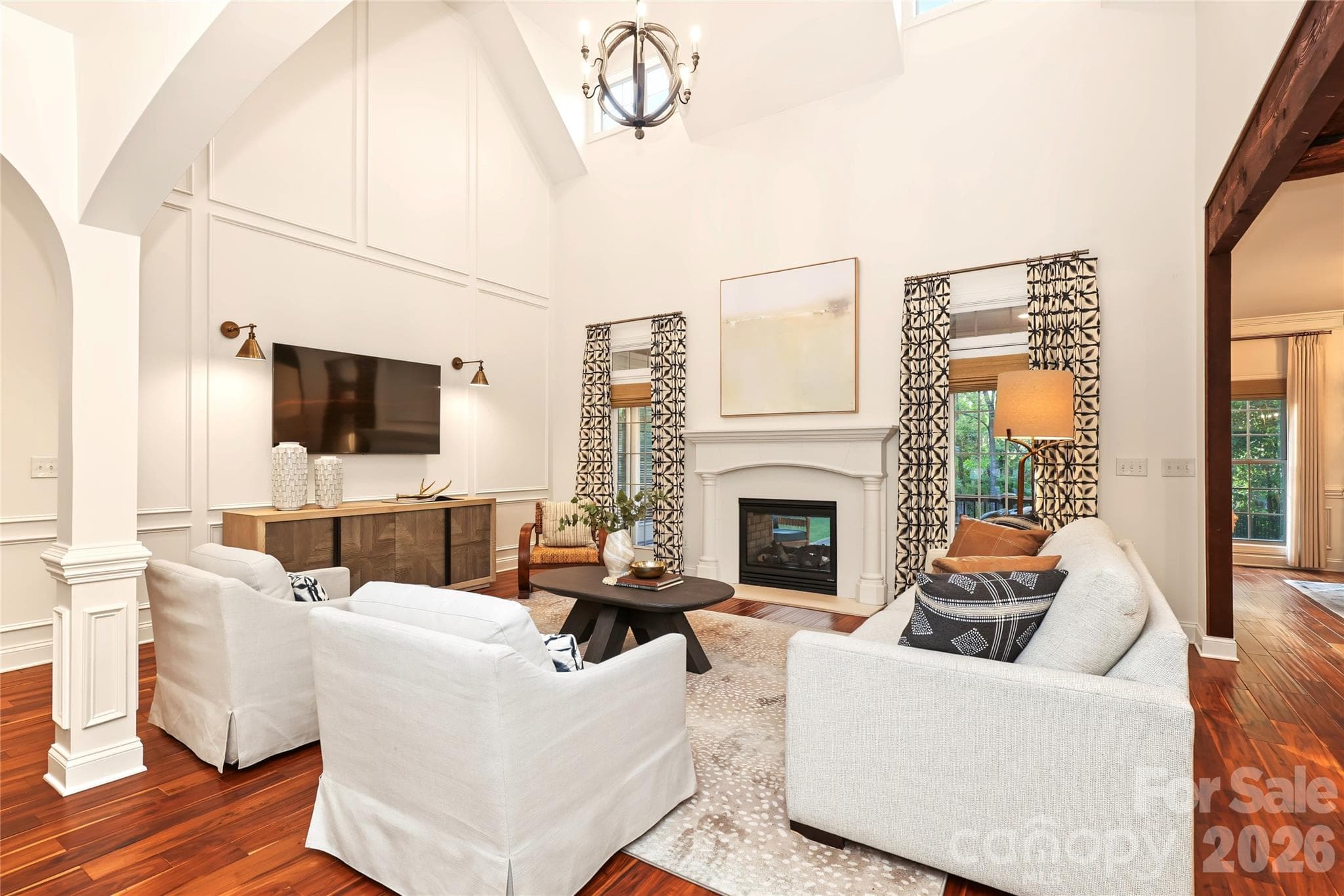 Light-filled Living Room with soaring ceilings and 2 sided fireplace - 4934 Spalding Place, Charlotte