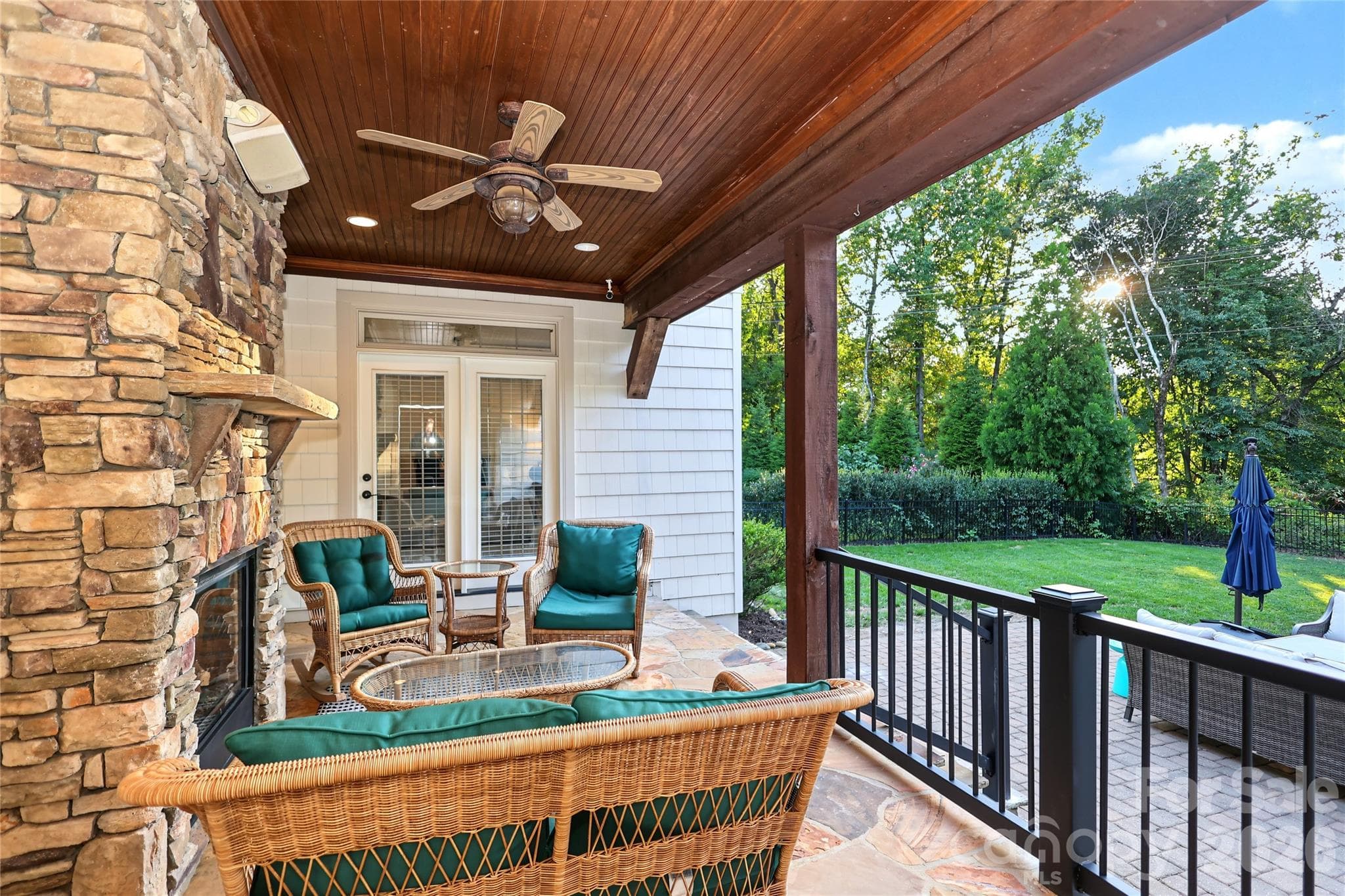 From the Dining Room, stepping out onto the back covered porch with fireplace. - 4934 Spalding Place, Charlotte