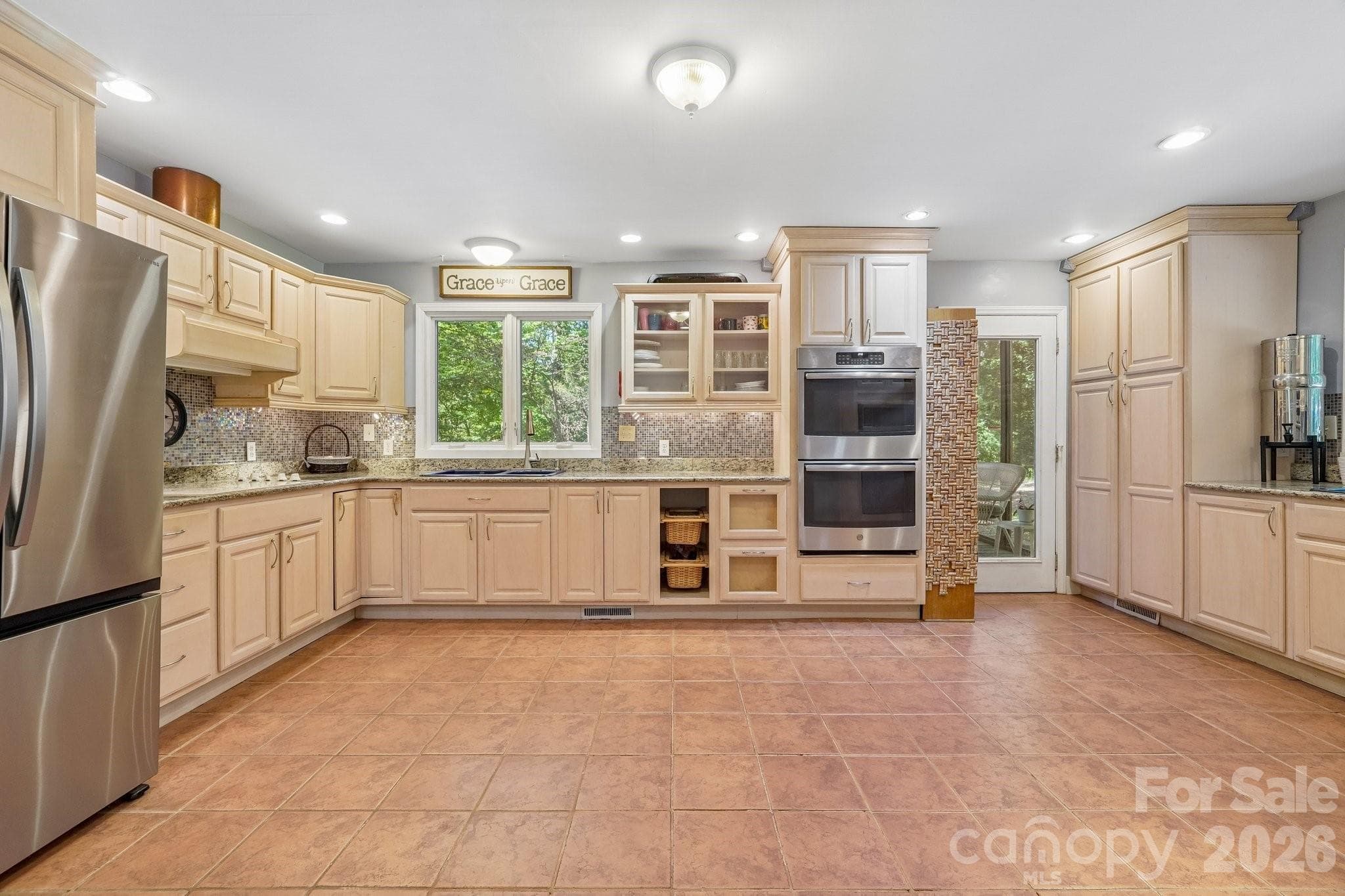Nice Open Kitchen with door leading out to screened-in porch and outdoor deck. - 2701 Cedar Trail Lane, Wingate