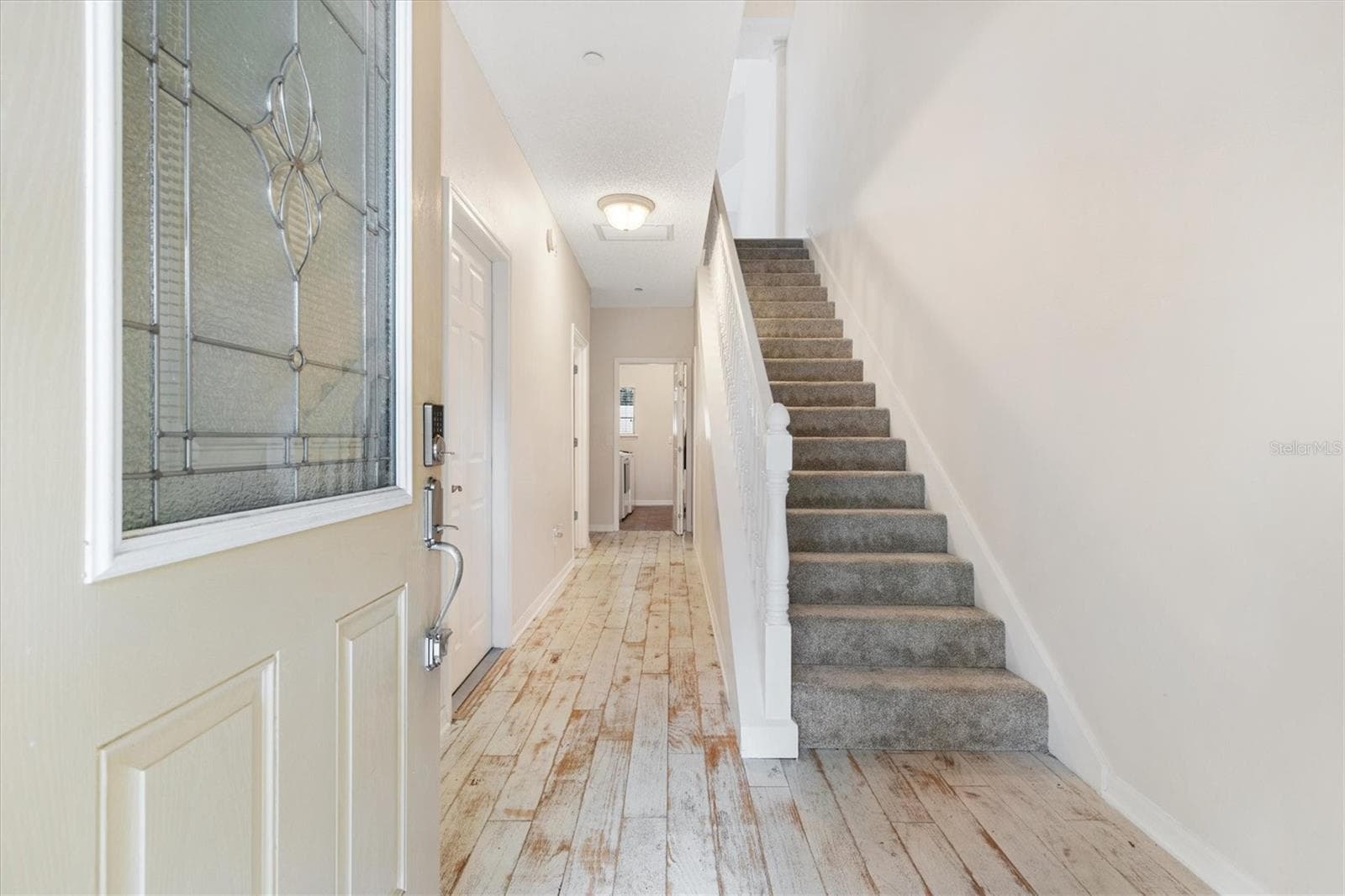 1sr Floor-Foyer w/ Distressed Engineered Wood Flooring. Carpet padded stairs. - 1212 AVENIDA DE LAS CASAS #0, THE VILLAGES