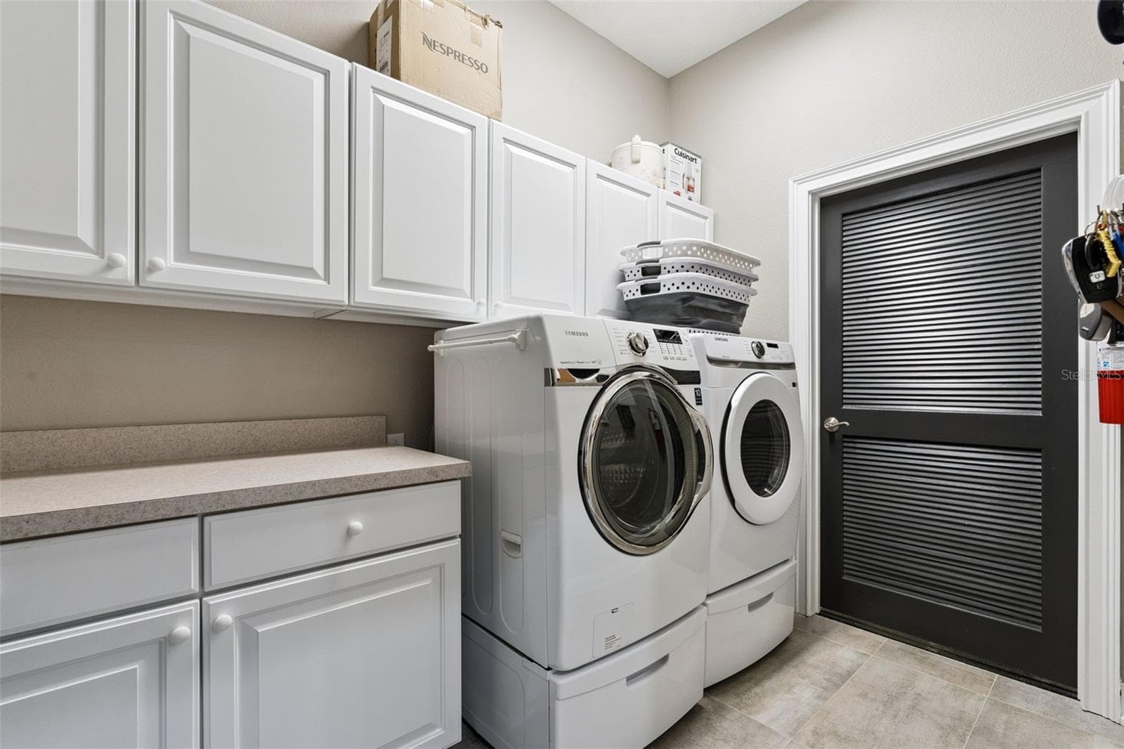 Laundry Room with washer & dryer and door to utility closet with sink, tankless water heater, and storage. - 225 W SEMINOLE BLVD #603, SANFORD