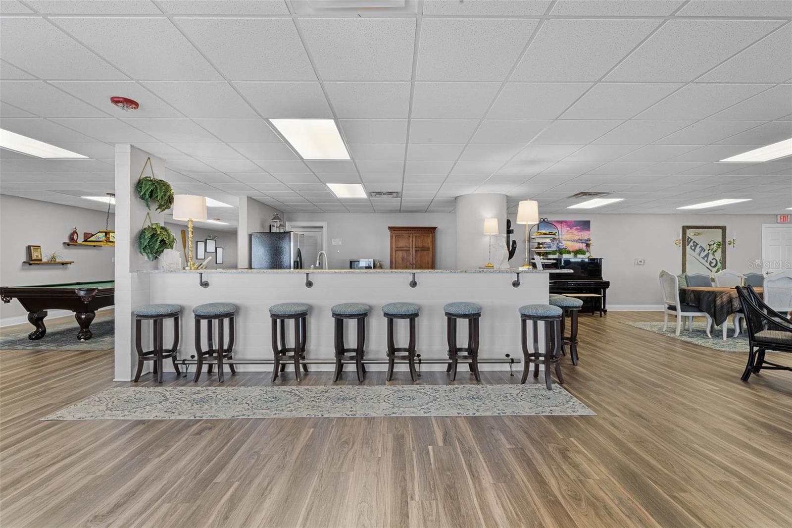 Clubhouse kitchen with bar seating and pool table. - 225 W SEMINOLE BLVD #603, SANFORD