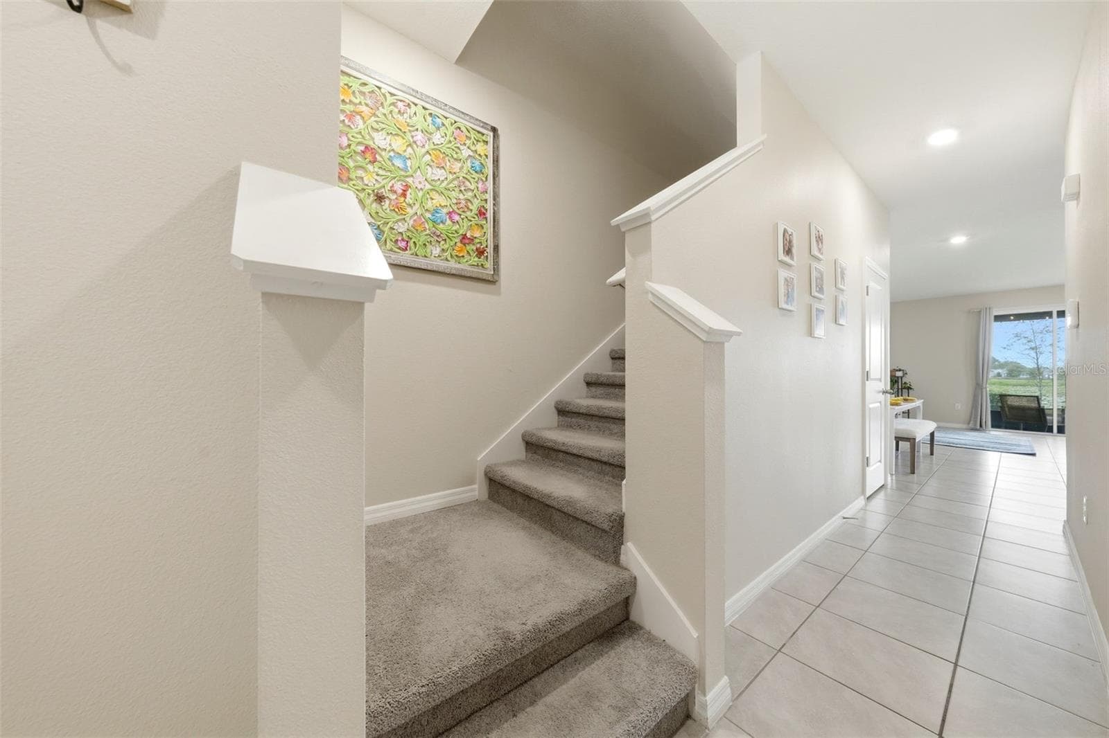 Staircase to upper level is toward the front of the home. - 5238 DRAGONFLY DR, WILDWOOD
