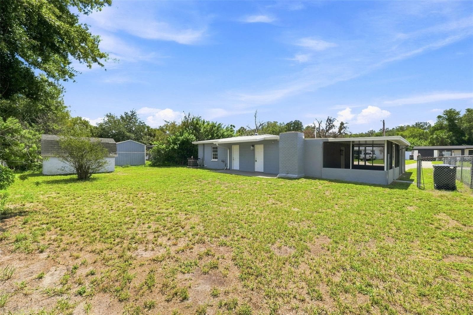 Generously sized, fully fenced backyard perfect for privacy and outdoor activities. - 8326 ENDIVE AVE, TAMPA