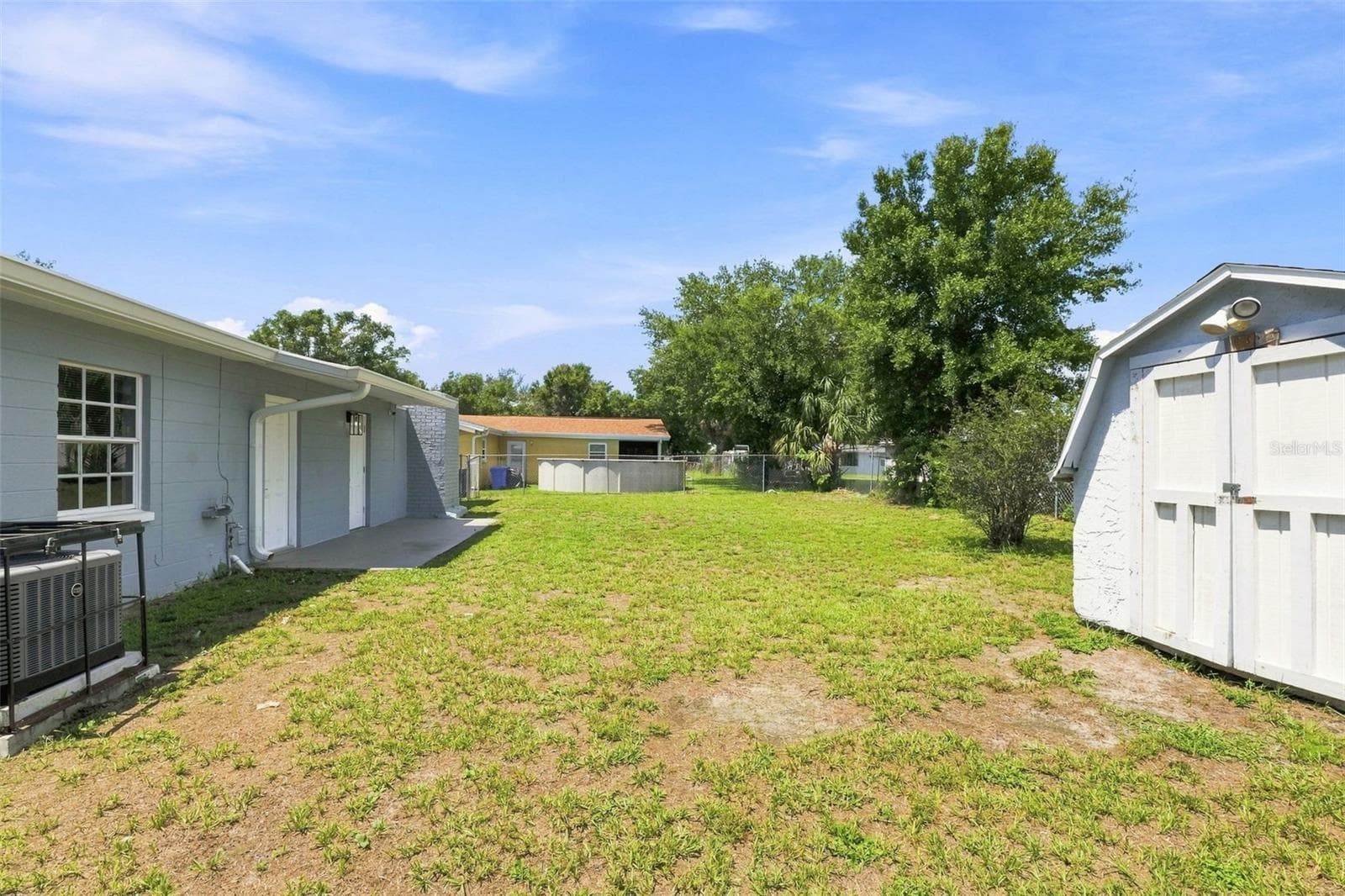 Backyard featuring an outdoor shed for storage or workshop use. - 8326 ENDIVE AVE, TAMPA