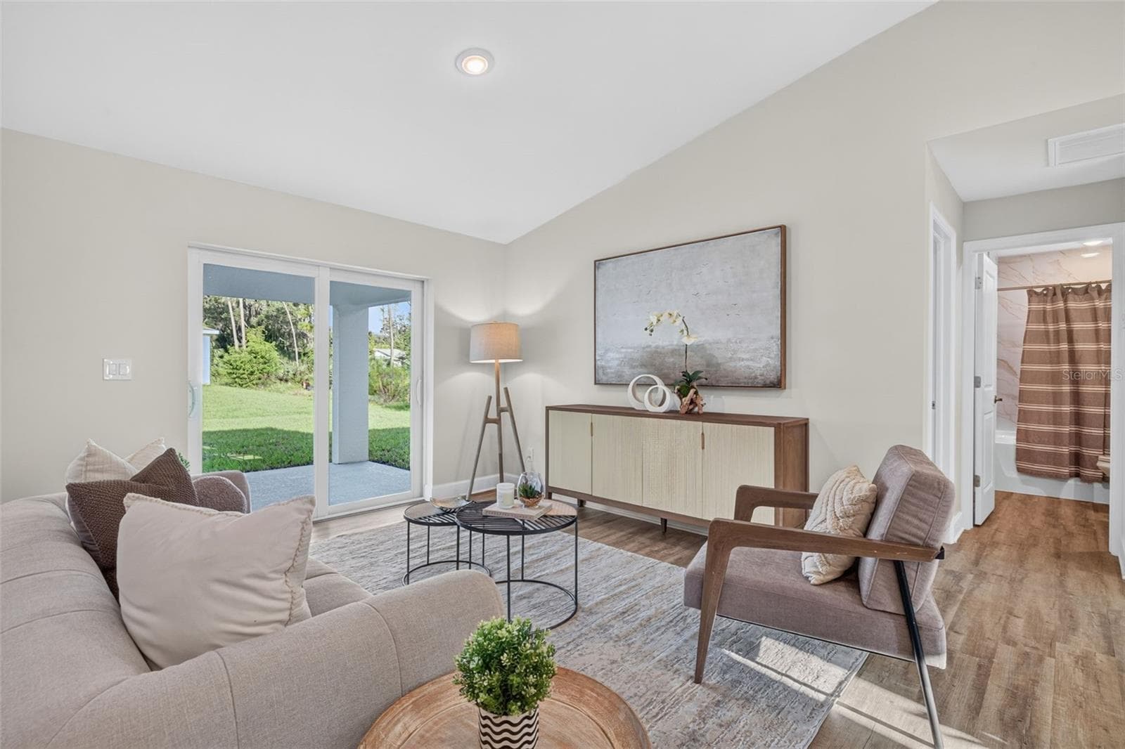 Staged living room with impact slider - 315 LINDON ST, PORT CHARLOTTE