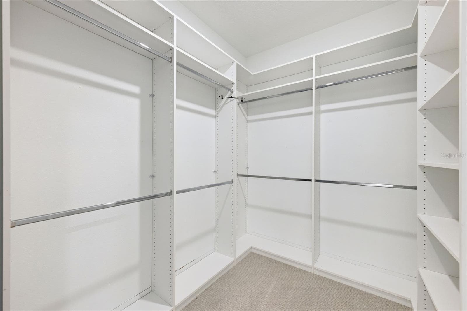 Primary bedroom walk-in custom closet - 1952 SUNSHINE PEAK DR, MINNEOLA