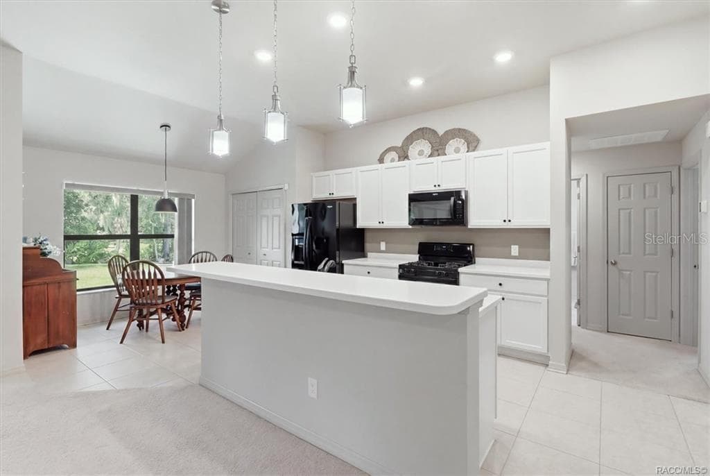 Kitchen w/ Breakfast Nook, White Cabinetry, Quartz Countertops, Black Appliances, Island w/ Raised Breakfast Bar & Pantry Closet - 2651 E MAIDSTONE CT, HERNANDO