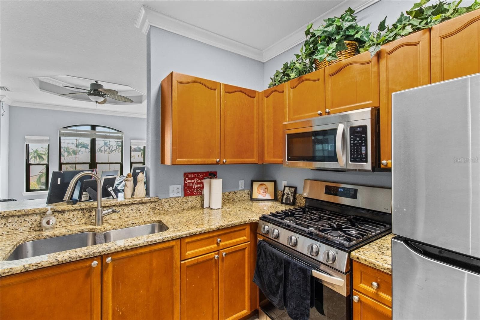 kitchen with views of the pool and palm trees - 2709 VIA CIPRIANI #532B, CLEARWATER