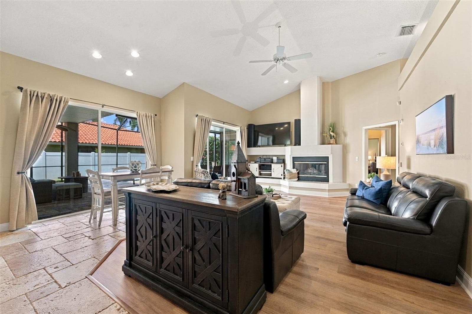 Family room with two sets of sliding glass doors to pool & wood burning fireplace - 2966 HILLCREEK CIR S, CLEARWATER