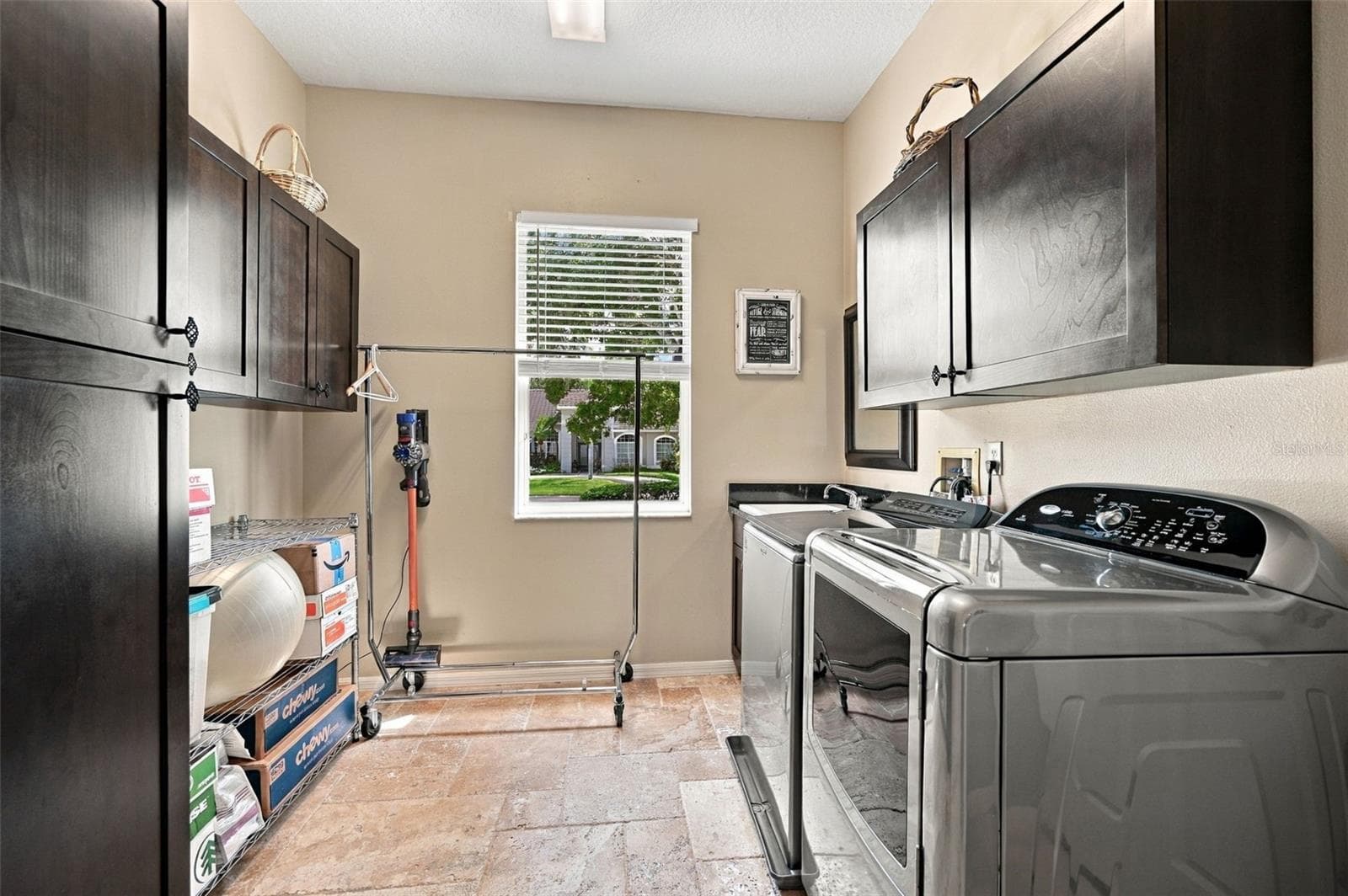 Primary Laundry with utility sink and storage cabinets - 2966 HILLCREEK CIR S, CLEARWATER