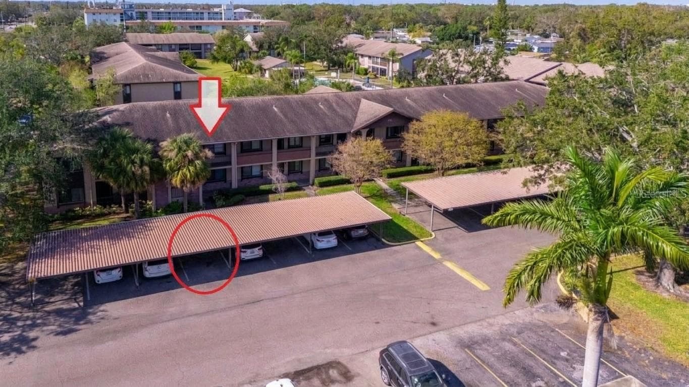 Covered parking space directly infront of unit entrance - 721 83RD AVE N #202, ST PETERSBURG